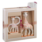 Giraffe-shaped toys in a decorative box with a visible brand logo.