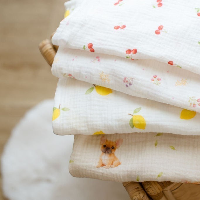 Baby NaturHere maxi muslin swaddle blankets with cherry, lemon, and French bulldog prints. 100% cotton.