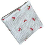 Baby Natur white muslin cloth with a red cherry print. Made from 100% cotton, perfect for babies.