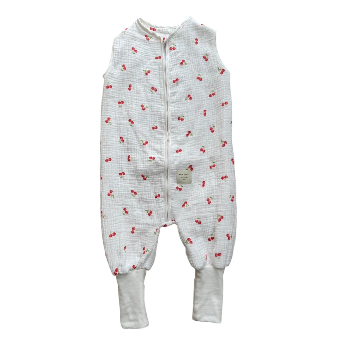Baby Natur white muslin sleep sack with all-over red cherry print and ribbed cuffs. Sleeveless design with front zipper.