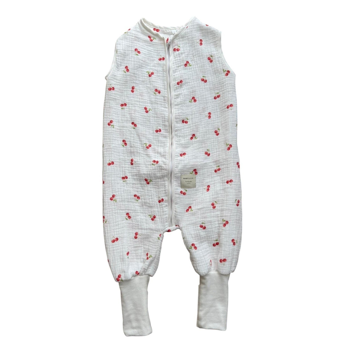 Baby Natur white muslin sleep sack with all-over red cherry print and ribbed cuffs. Sleeveless design with front zipper.