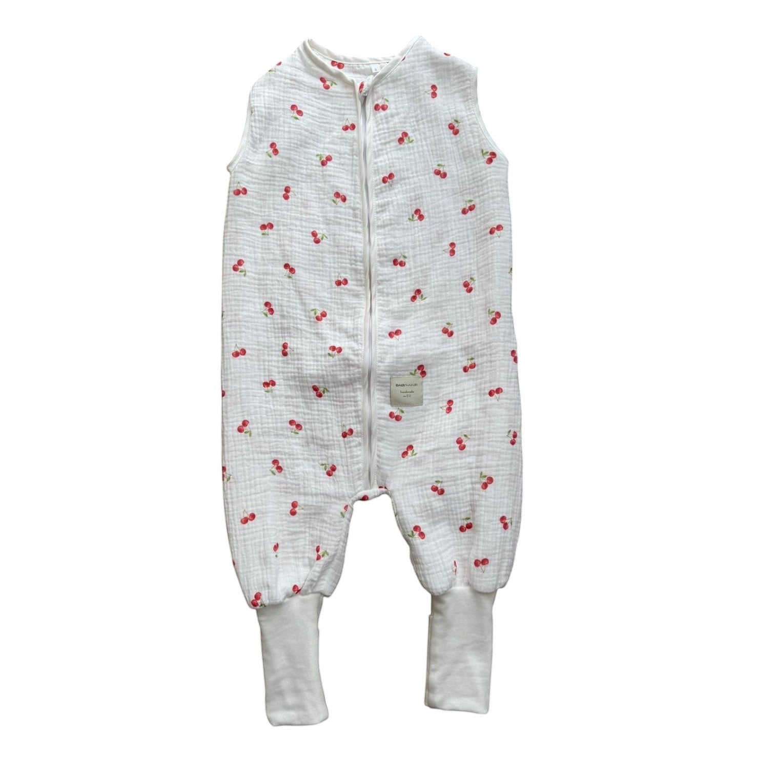 Baby Natur white muslin sleep sack with all-over red cherry print and ribbed cuffs. Sleeveless design with front zipper.