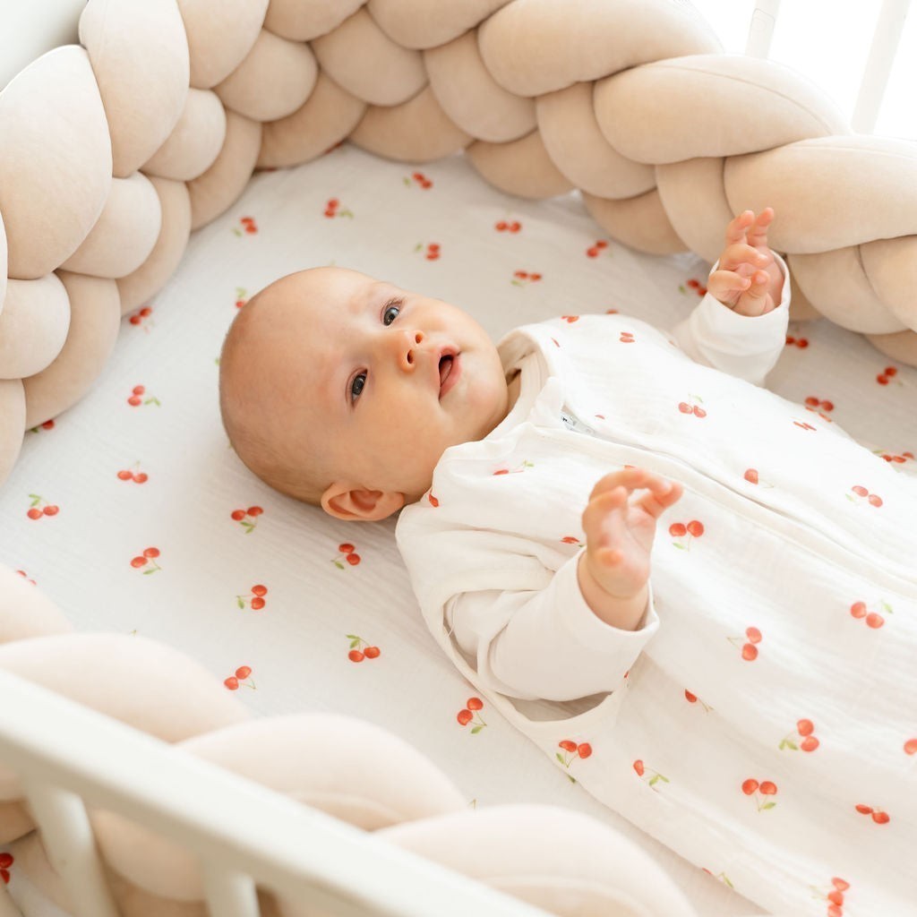 Baby Natur white sleeveless sleeping bag with cherry print, made of soft, breathable cotton for safe and comfortable sleep.