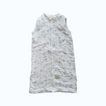 Baby Natur sleeveless sleeping bag with a white background and a delicate floral print in pink and yellow. Made from soft, breathable cotton.
