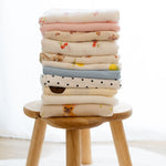 Baby NaturStack of 100% cotton muslin cloths with cute prints like cherries, bears, and dogs. Soft, absorbent, and washable.