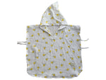 Baby Natur white muslin baby poncho with yellow lemon print and hood. Features tie closures on sides.