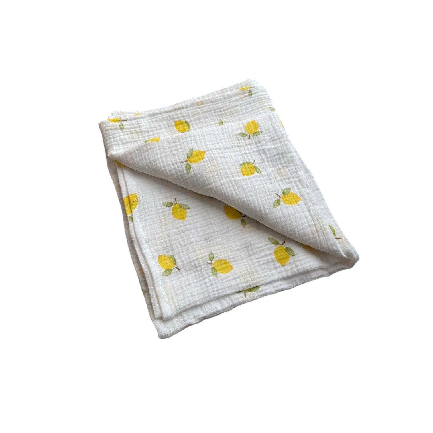 Baby Natur muslin blanket with a white background and a pattern of yellow lemons and green leaves. Soft and breathable.