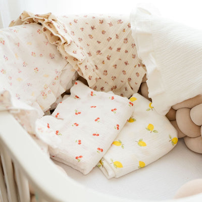 Baby NaturMuslin swaddles with cherry, lemon, and floral prints. Soft, breathable, and perfect for nurseries.