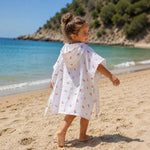 Baby Natur white muslin poncho for kids with cherry print, hooded, perfect for beach or pool.